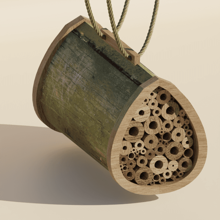 A bamboo and moss bee hotel swinging from its ropes